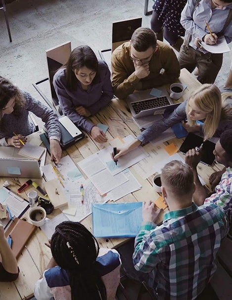 A project meeting around a table in an office setting.